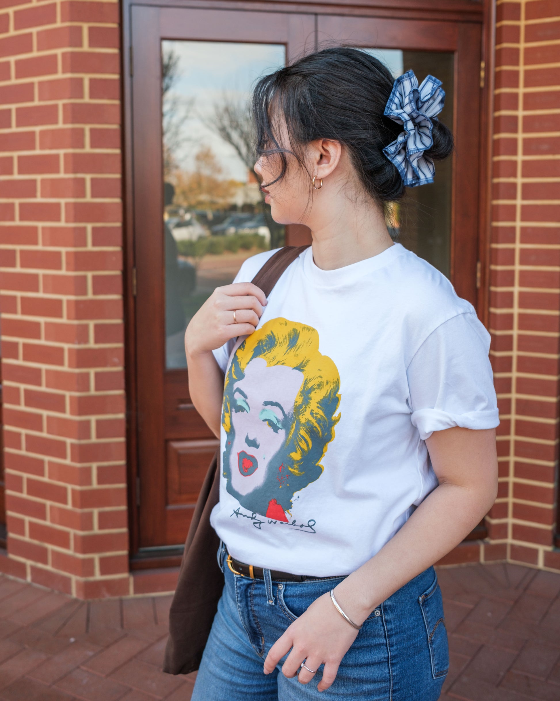 model wearing juniq brand scrunchie, blue stripes, overlocked trim, double layers