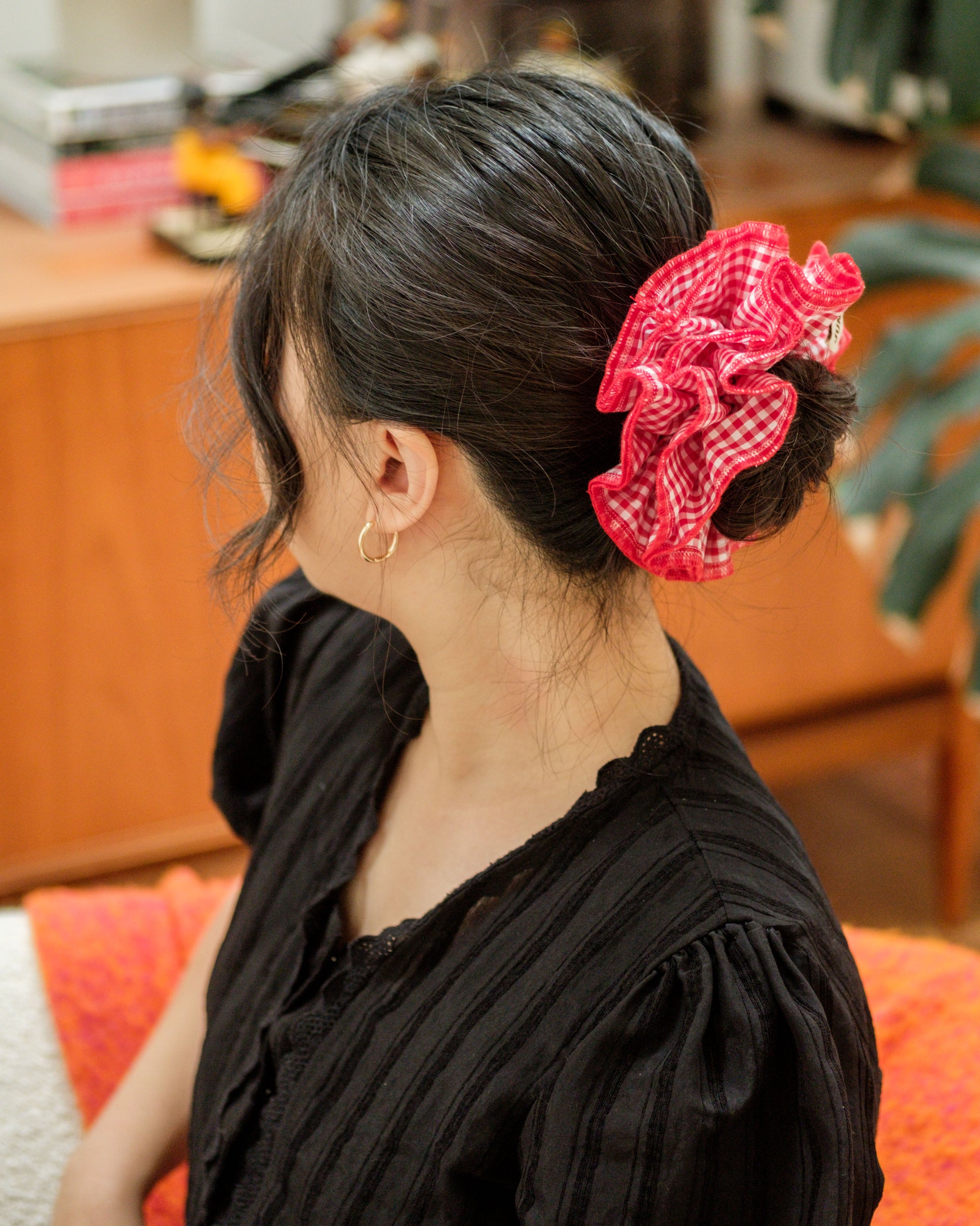 model wearing juniq brand scrunchie, red gingham checkered, red overlocked trim, quad layers