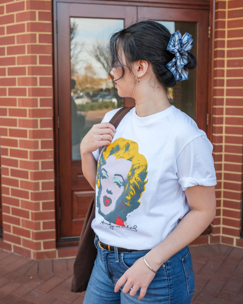 model wearing juniq brand scrunchie, blue stripes, overlocked trim, double layers