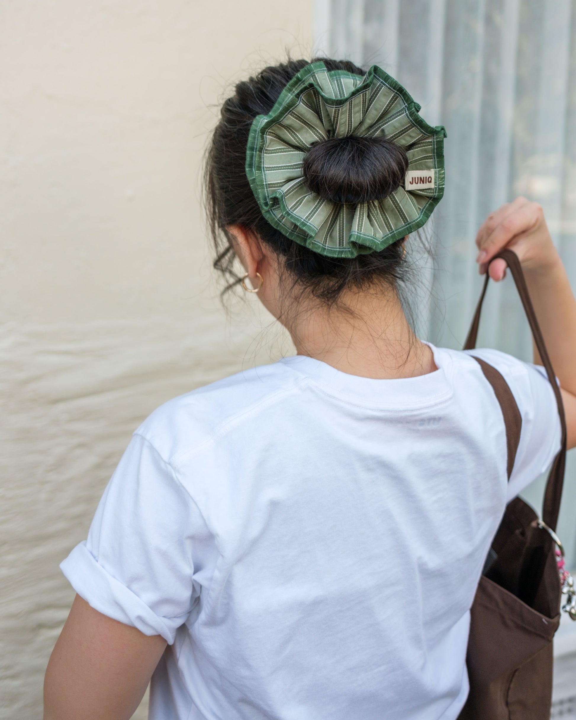 model wearing juniq brand scrunchie, sage/green stripes, overlocked trim, double layers